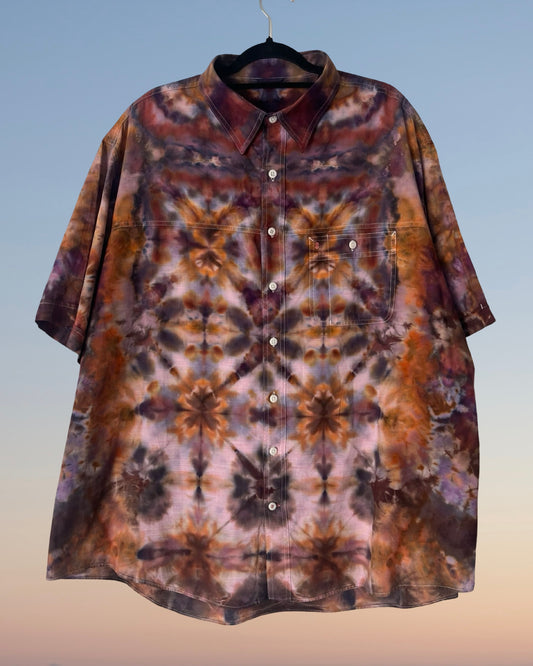 Tie-dye patterned shirt on a hanger with a gradient background