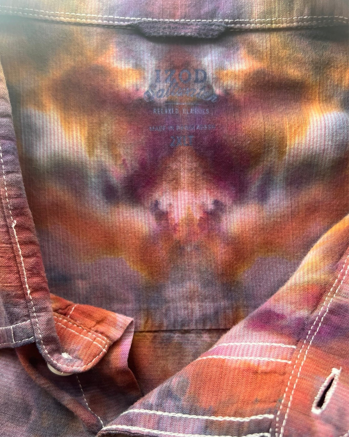 Close-up of a tie-dye shirt with a brand label on a blurred background