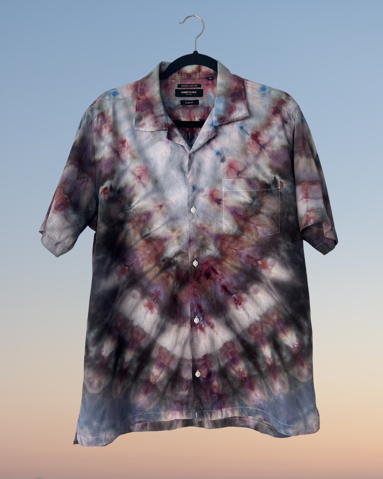 Tie-dye shirt on a hanger with a gradient background