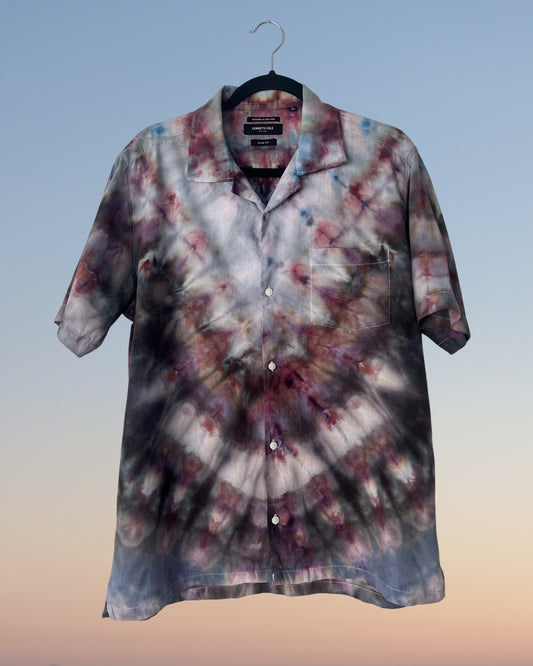 Tie-dye shirt on a hanger with a gradient background