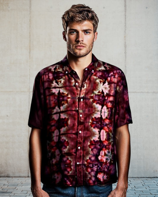 Man wearing a tie dye shirt against a neutral background