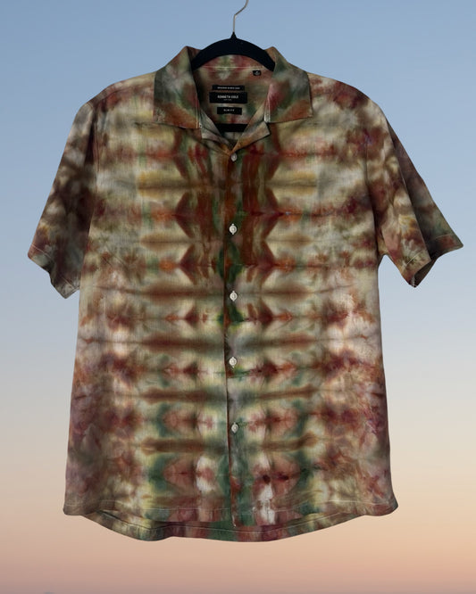 Tie-dye patterned shirt on a hanger with a gradient background