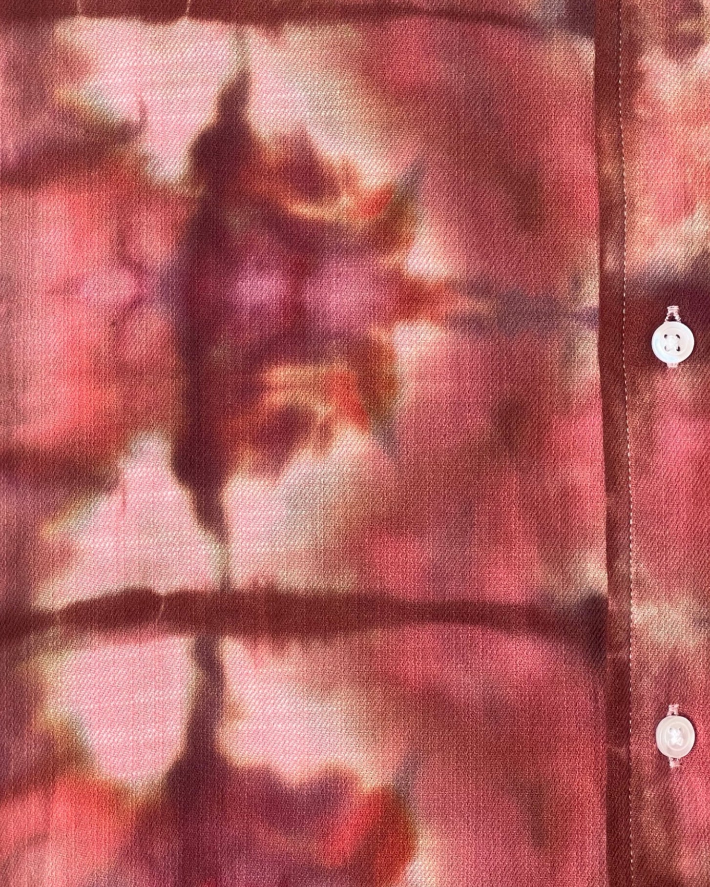 Tie-dye shirt with a pattern of pink, purple, and brown colors.