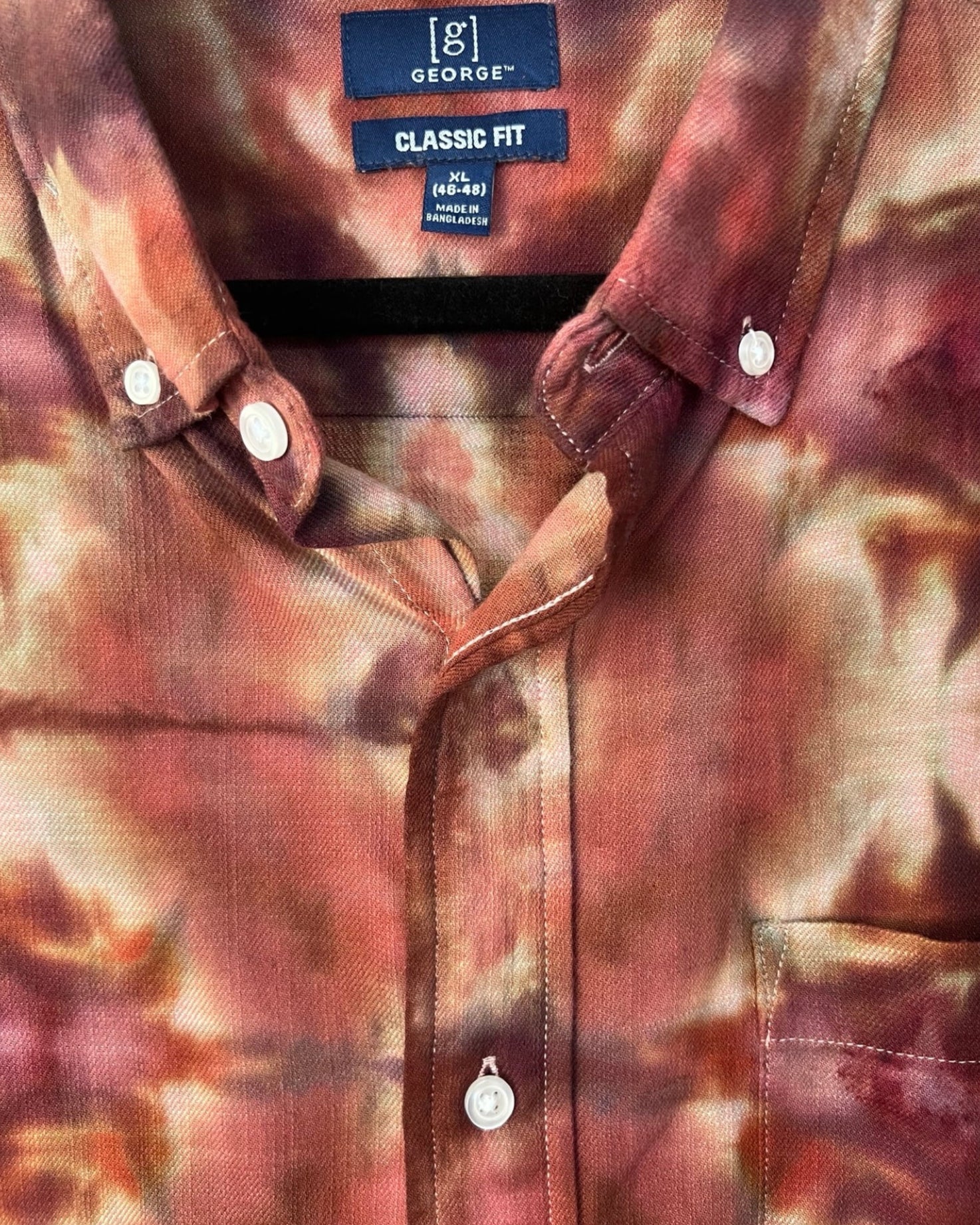 Close-up of a tie dyed shirt with branding