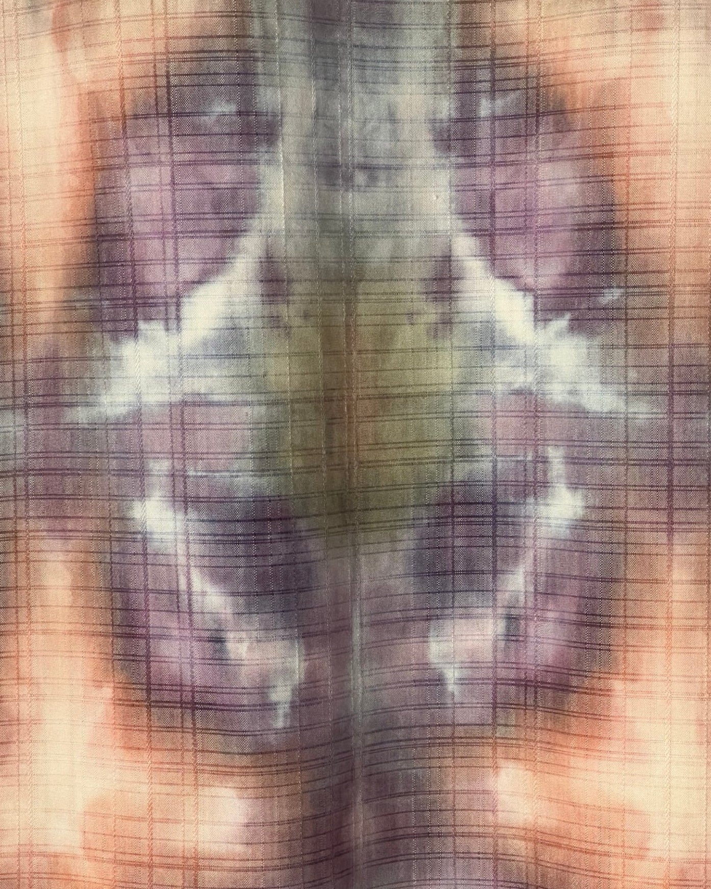 Textured fabric with ice dye pattern in brown, purple, and beige tones.