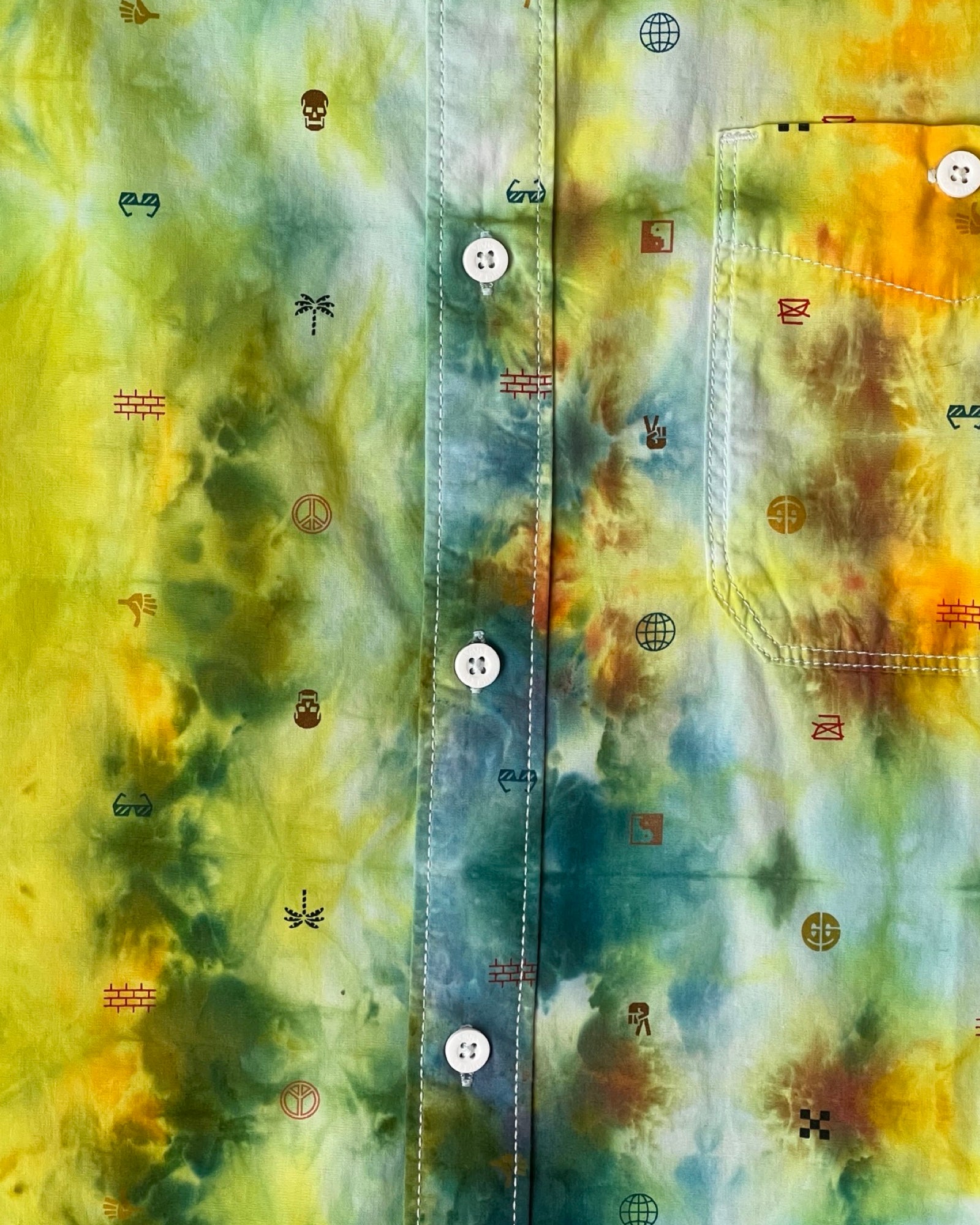 Colorful tie-dye fabric with abstract patterns and symbols.