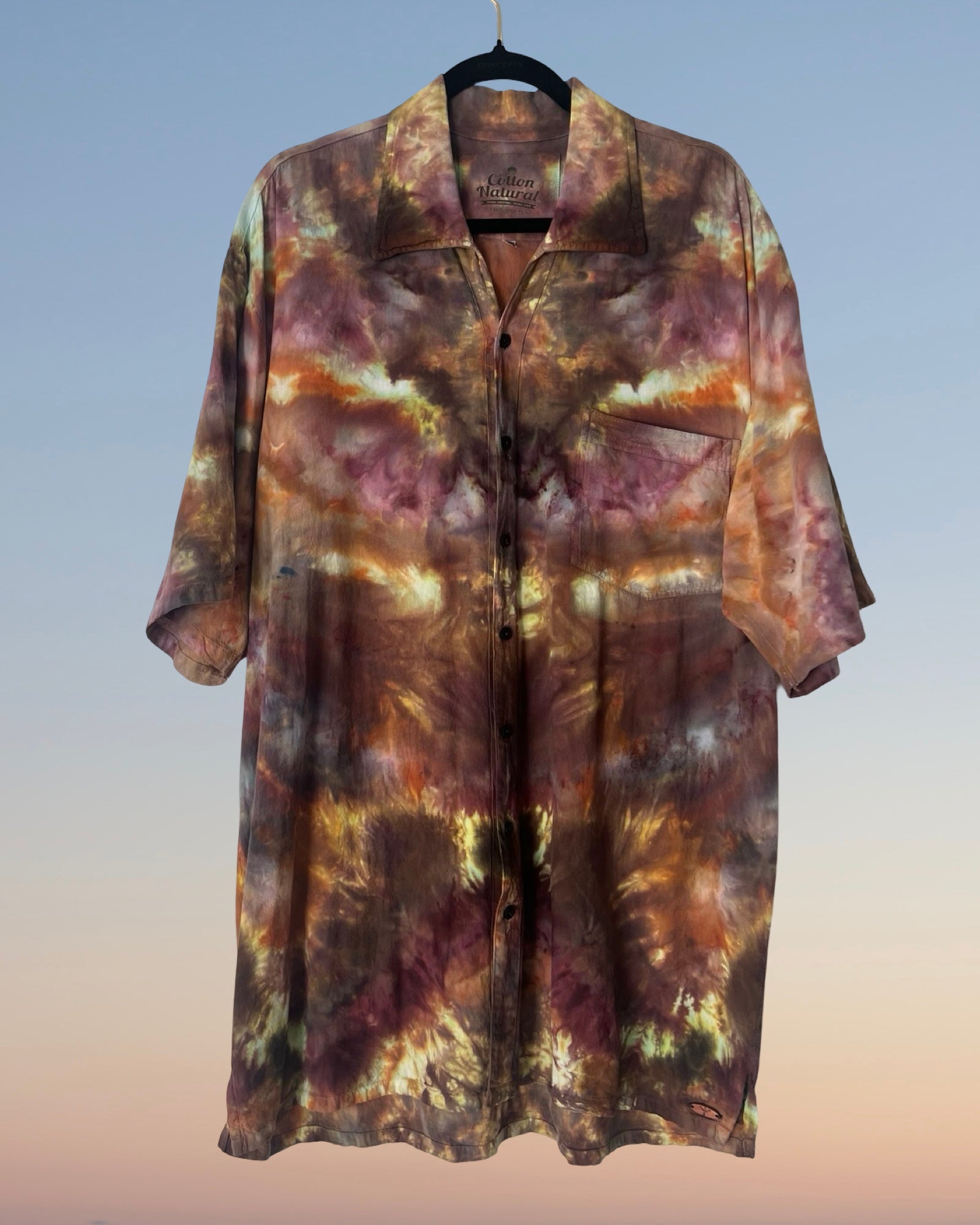 Tie-dye shirt on a hanger with a gradient background