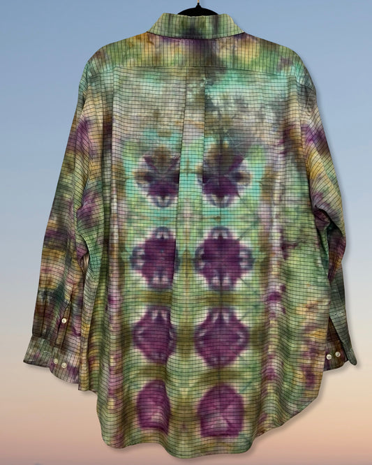 Long-sleeve tie dyed shirt with a pattern of purple shapes on a light blue background