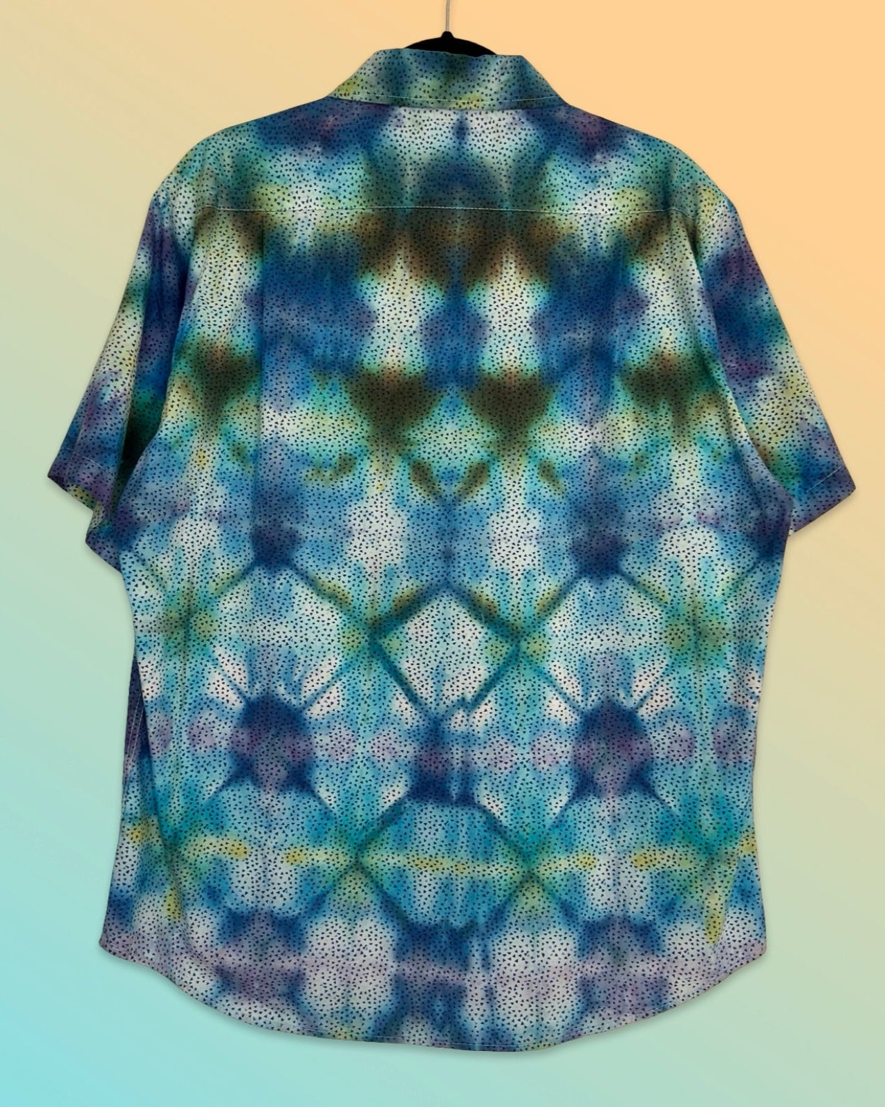 Tie-dye patterned shirt on a gradient background