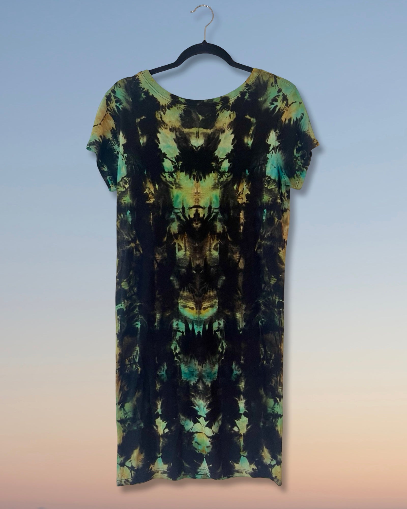 Tie-dye dress on a hanger against a gradient background