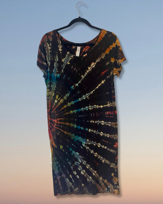 Tie-dye dress on a hanger against a gradient background
