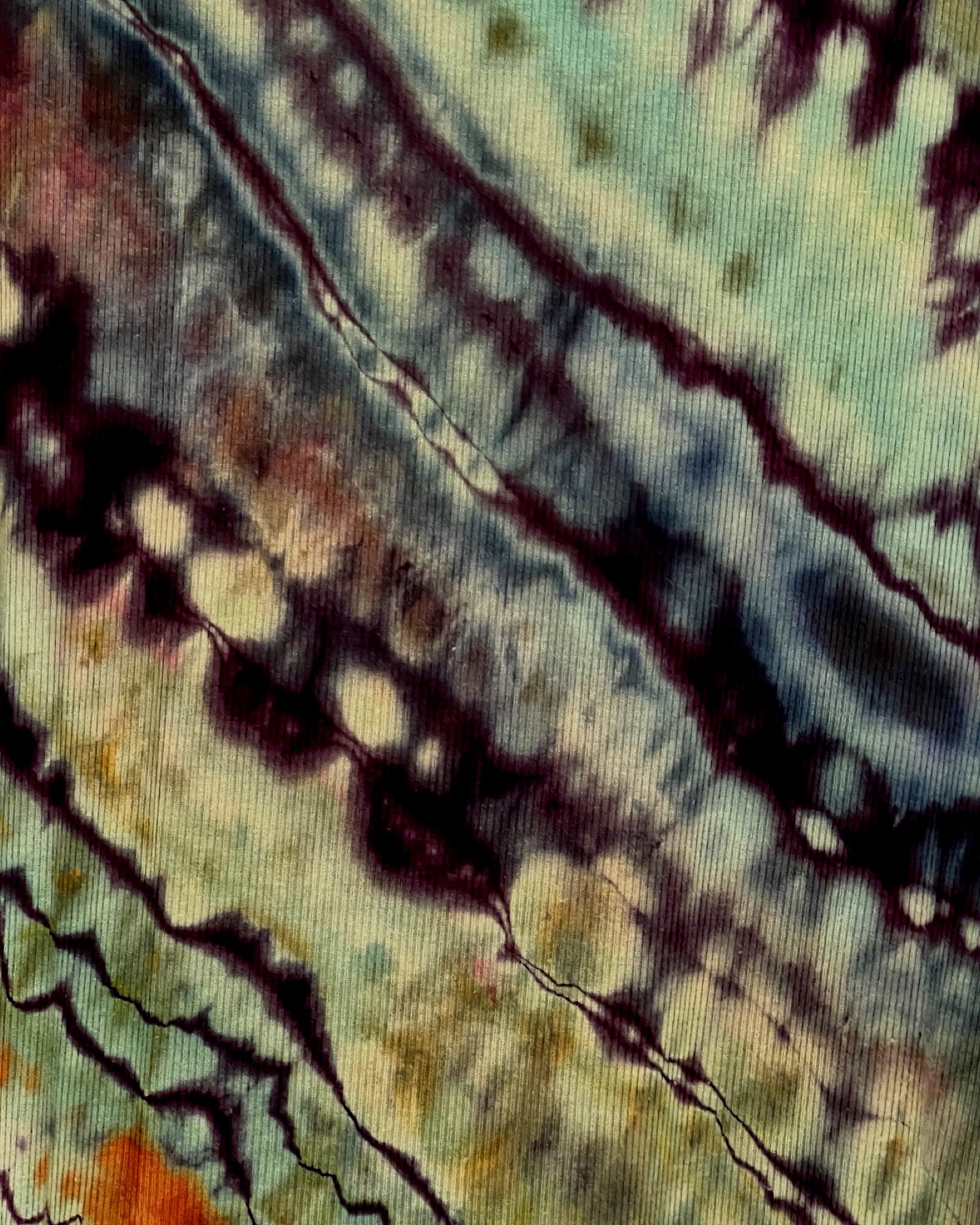 Close-up of tie-dye fabric with multicolor pattern
