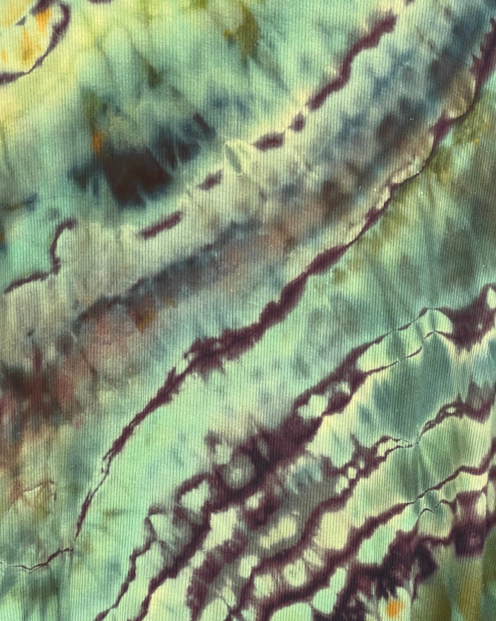 Textured fabric with green and brown abstract pattern