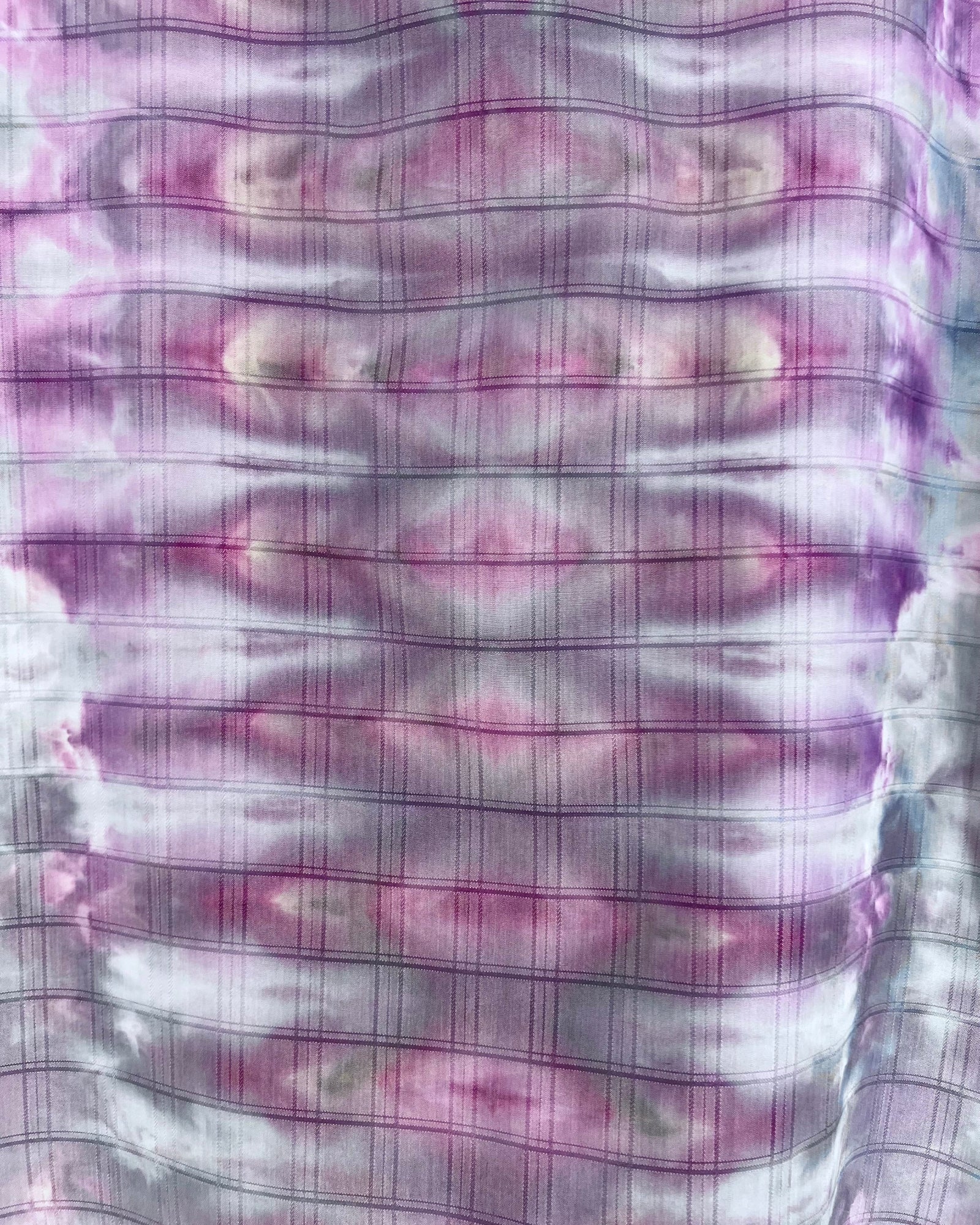 Close-up of a fabric with purple and white checkered pattern and ice dye 