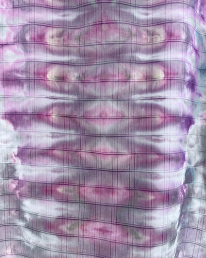 Close-up of a fabric with purple and white checkered pattern and ice dye 