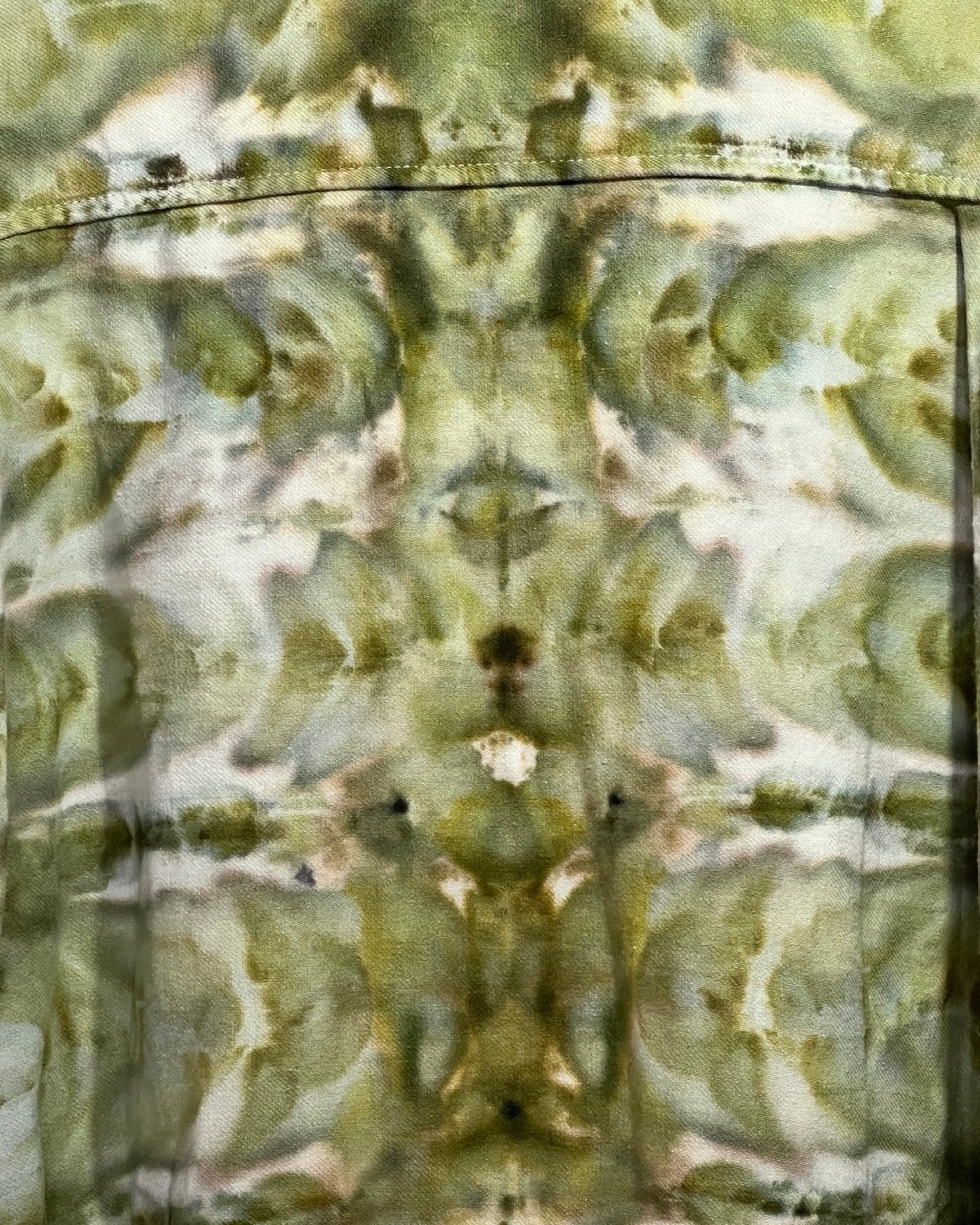 Close-up of a camouflage tie dye fabric with a reflective surface.