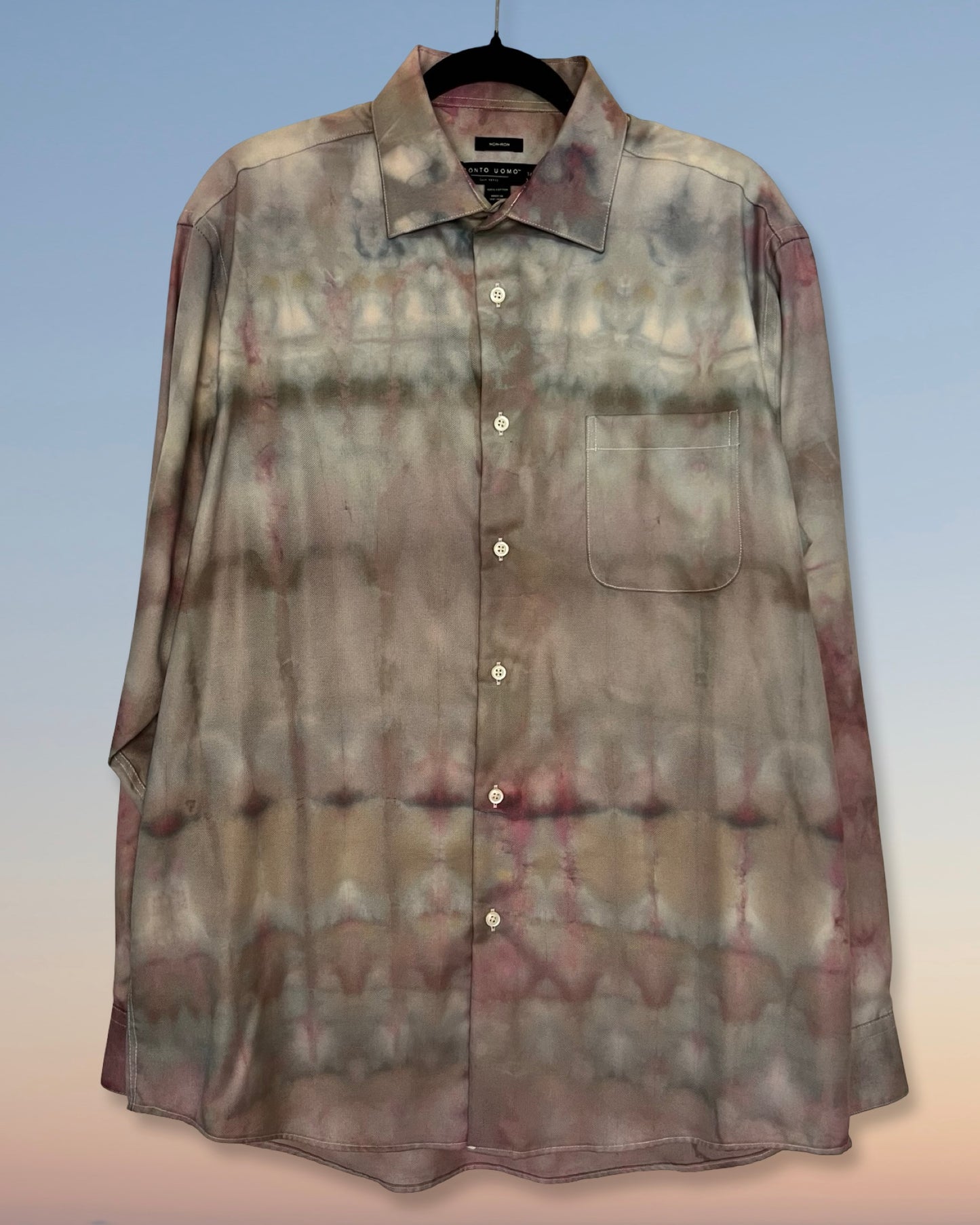 Tie-dye shirt on a hanger with a gradient background