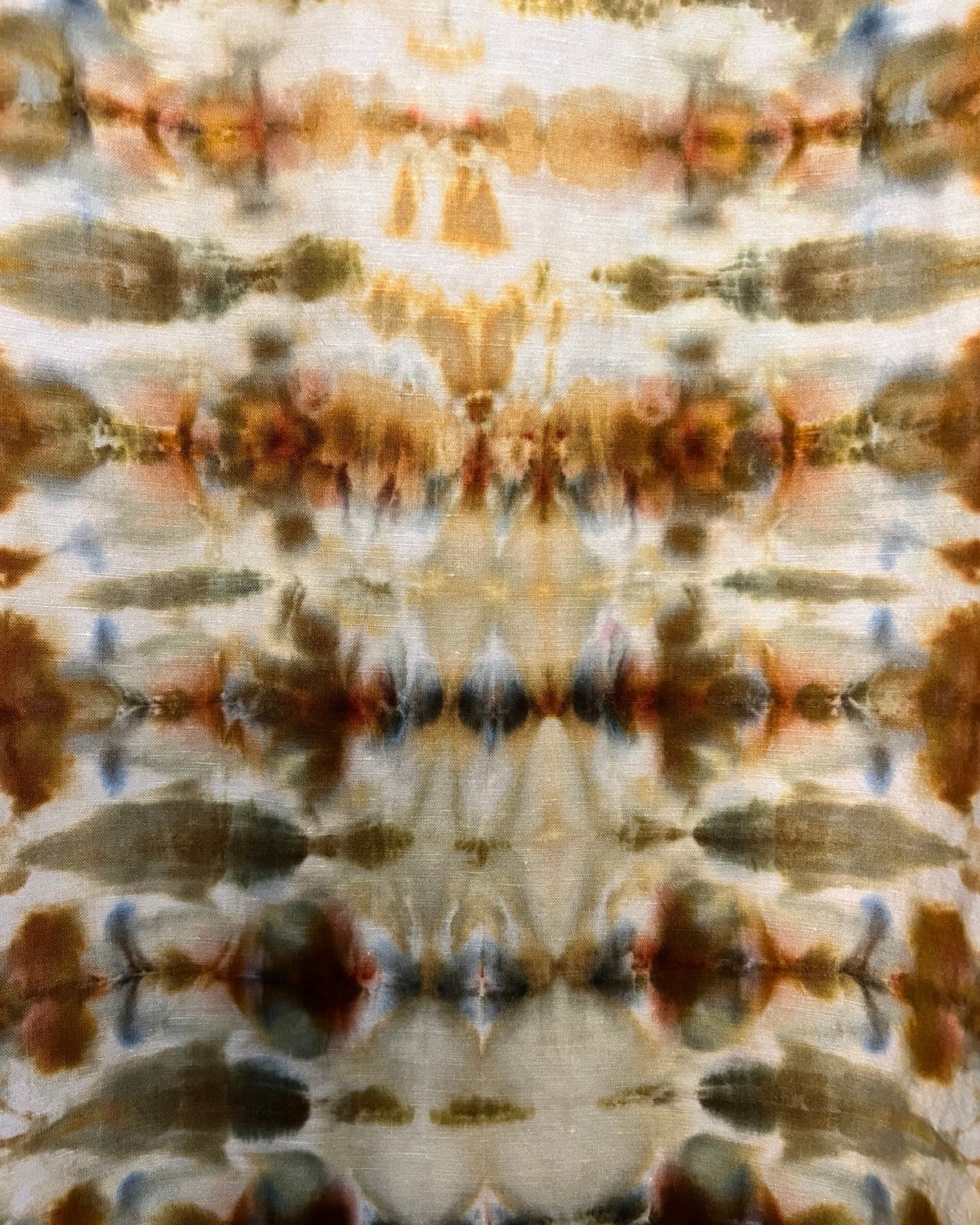 Tie-dye pattern with earthy tones on a fabric background