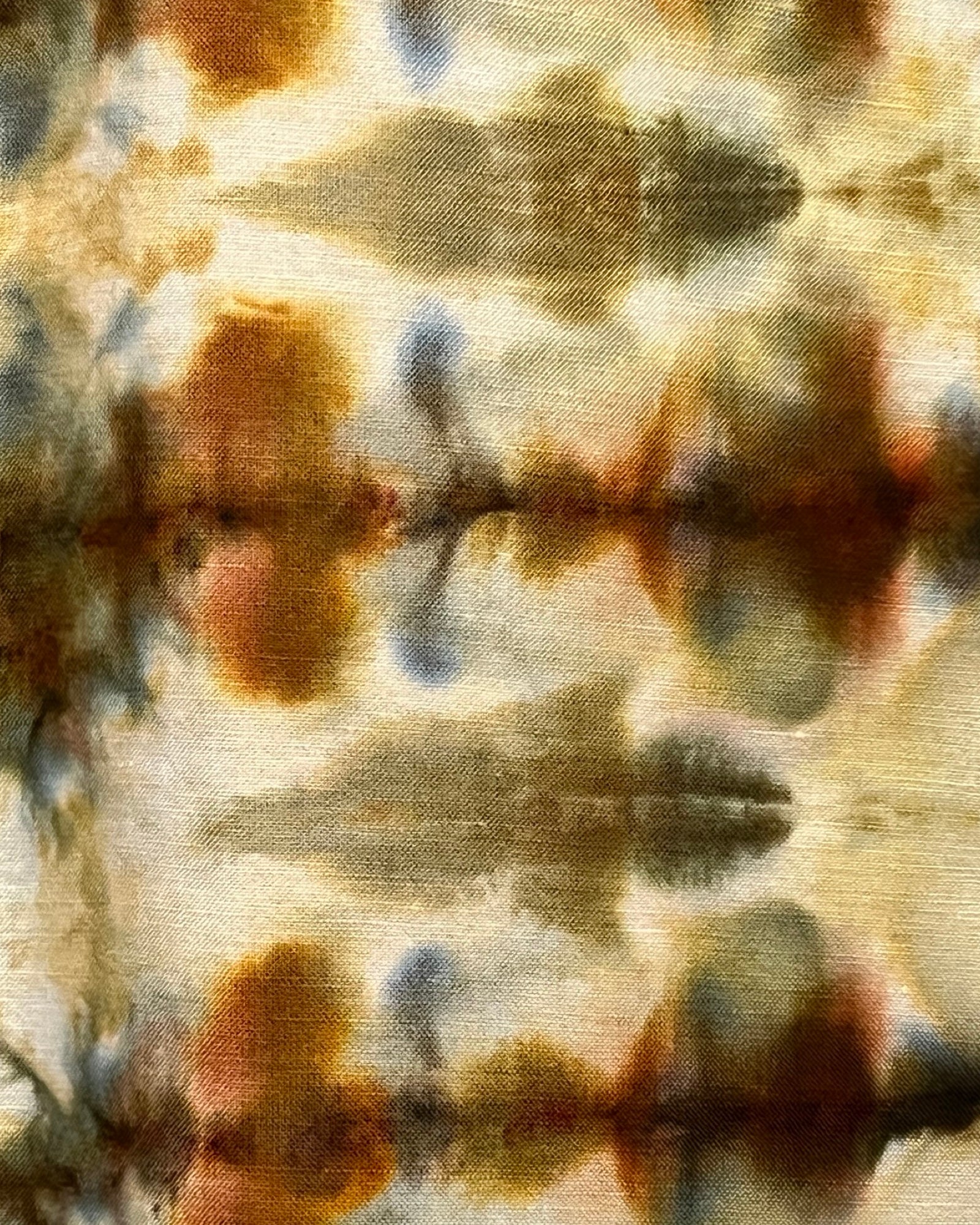 Abstract tie-dye pattern with brown, blue, and beige colors on a fabric background.