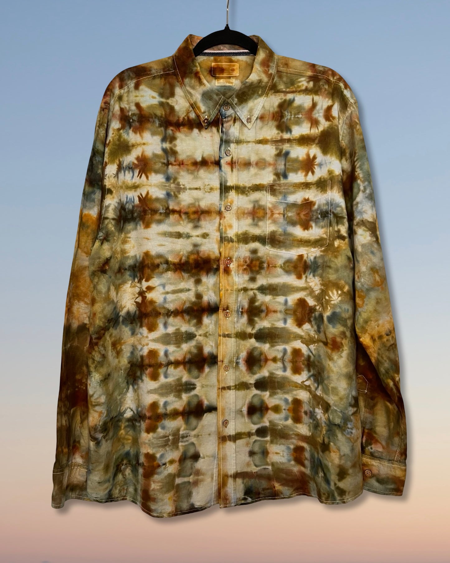 Tie-dye shirt with brown and beige pattern on a gradient background