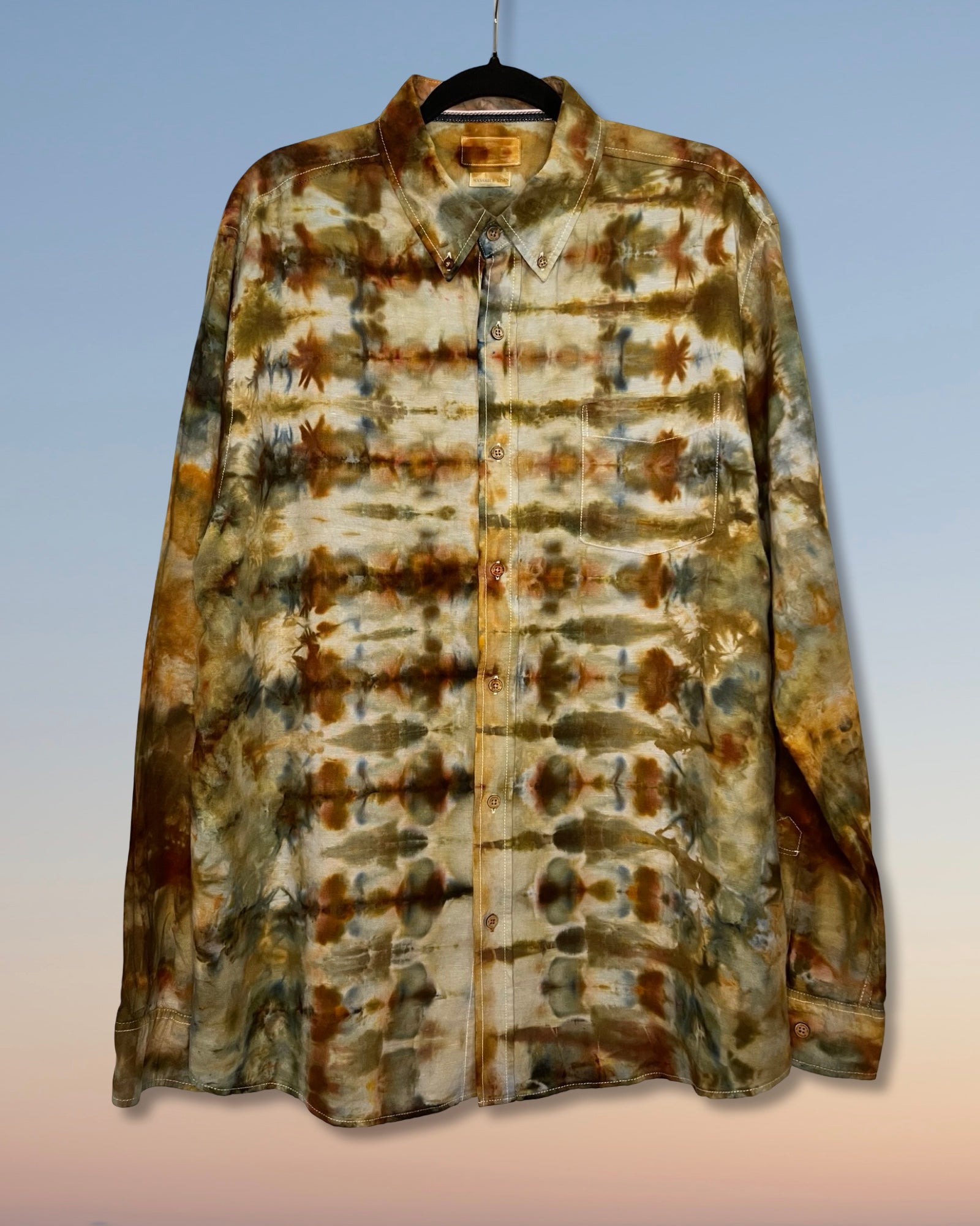 Tie-dye shirt with brown and beige pattern on a gradient background