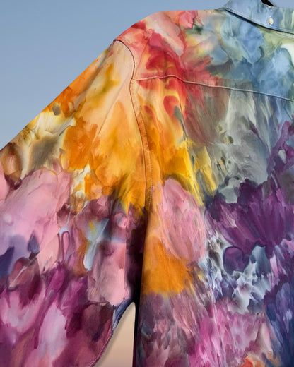 Close-up of a colorful floral tie dye pattern on a fabric surface.