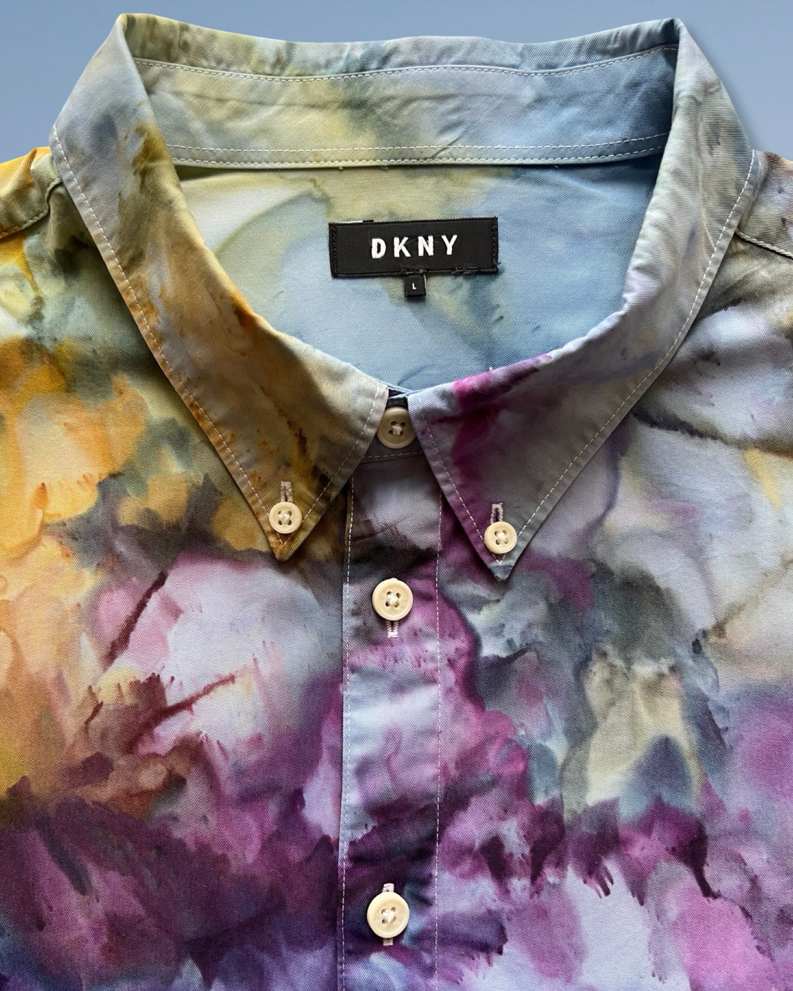 rainbow tie-dye pattern and brand label on a gray background