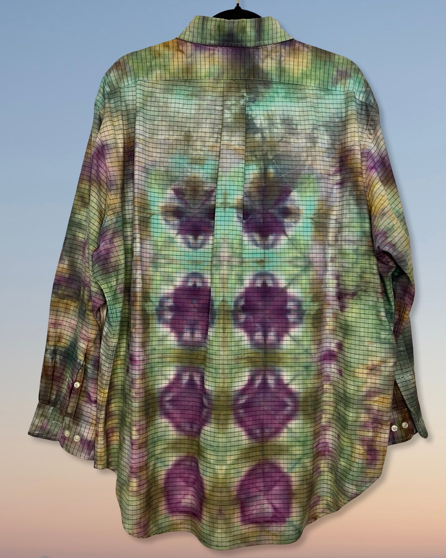 Long-sleeve tie dyed shirt with a pattern of purple shapes on a light blue background