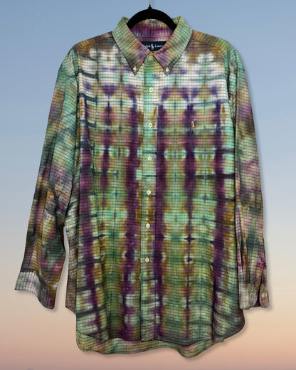 Tie dyed plaid shirt with purple and green pattern on a light gray background