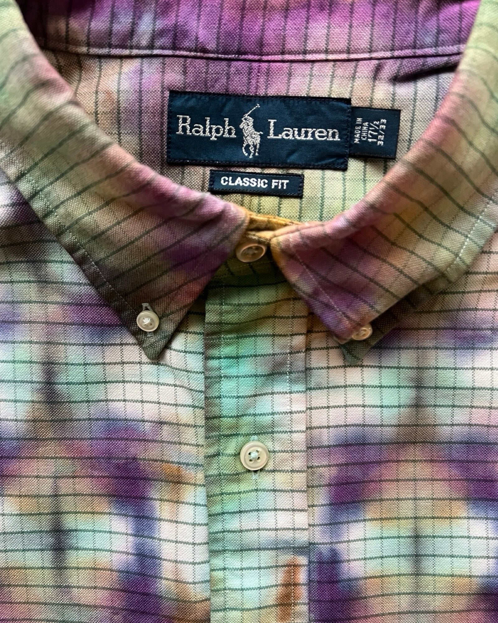 Tie dye shirt with label detail 'Classic Fit' on a multicolored background