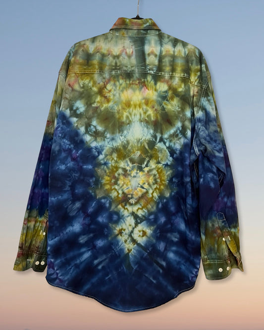 Tie-dye shirt with blue and green patterns on a plain background