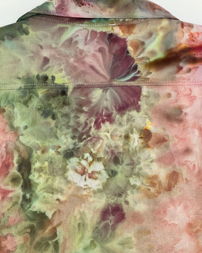 Close-up of a tie-dye pattern with pink, green, and brown colors.