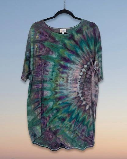 Tie-dye shirt on a hanger with a gradient background