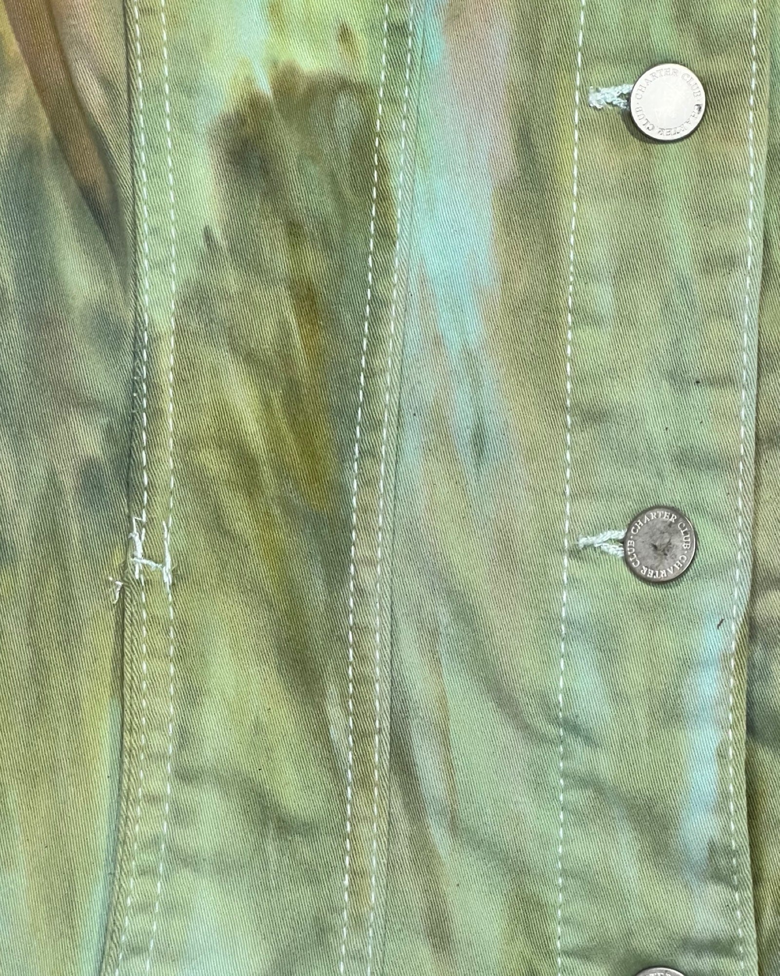 Close-up of a tie-dye shirt with button details