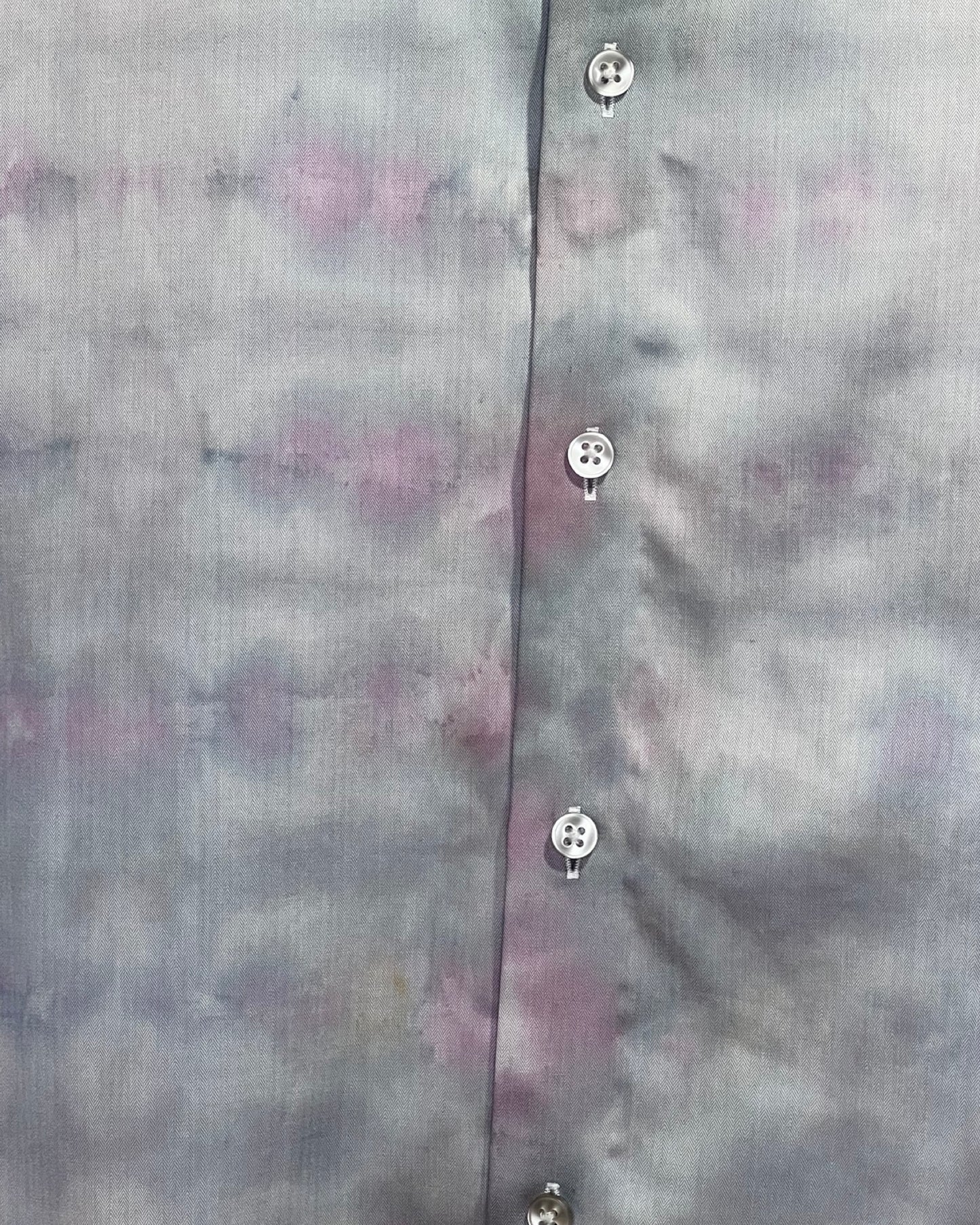 Close-up of a shirt with tie dye pattern and button details